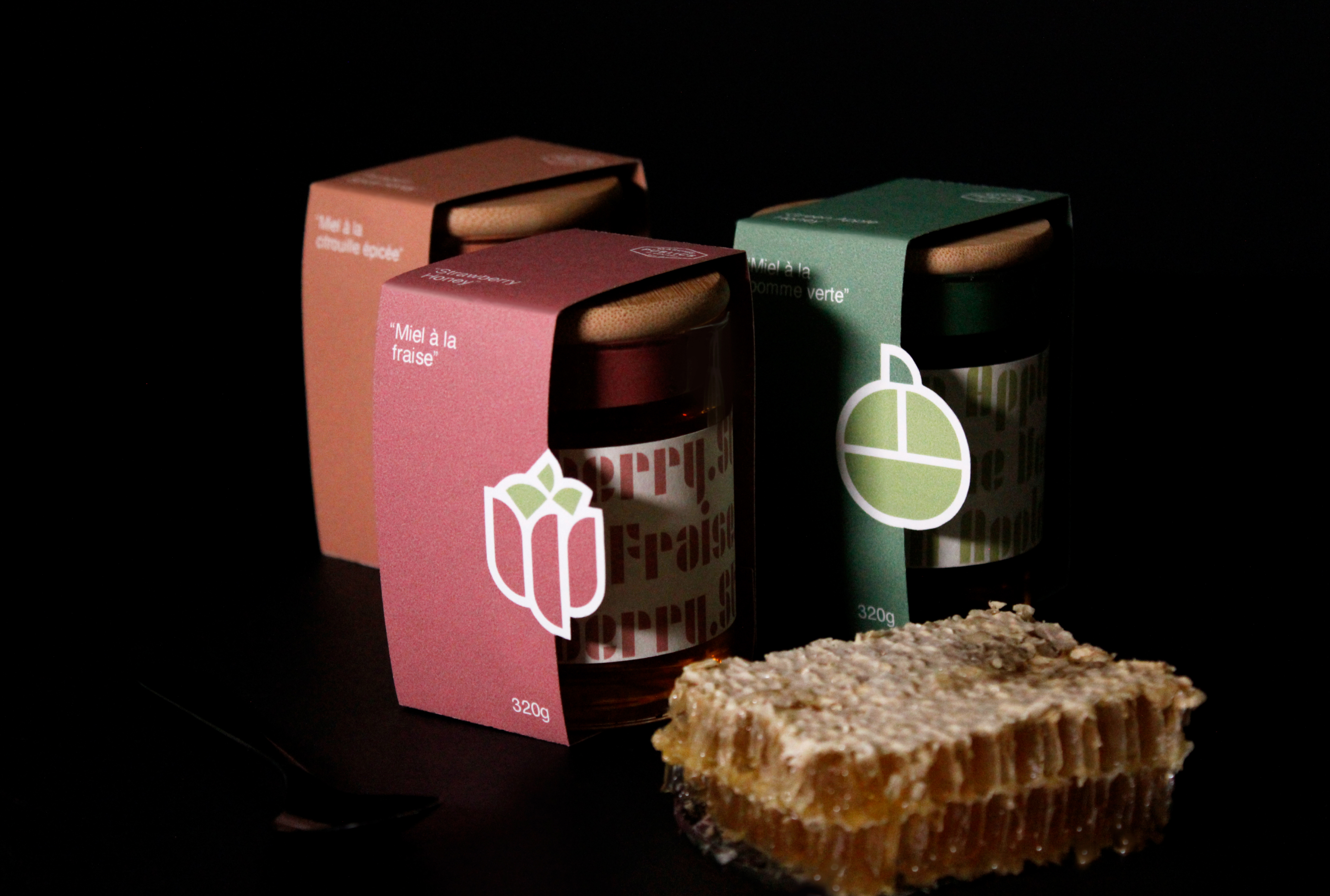 picture of three jars and labels with honeycomb and spoon